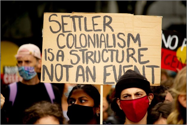 'Settler colonialism is a structure not an event' rally banner