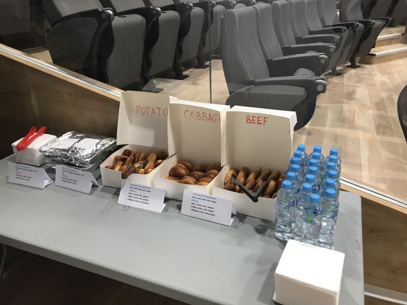 Boxes of pirozhki on table in Forum Theatre.