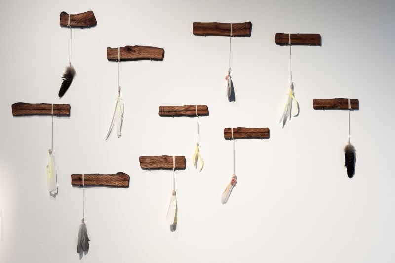 A variety of message sticks made out of wood and animal feathers. Anthony Walker