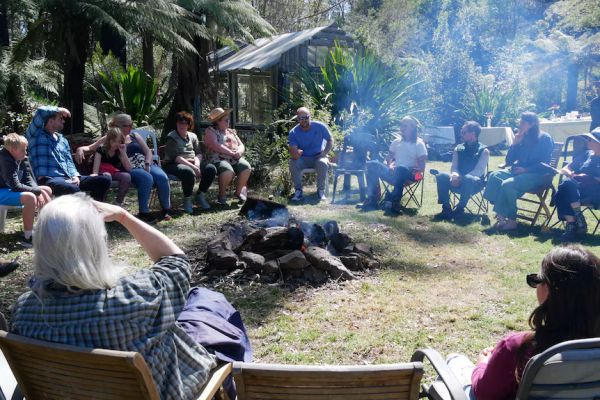 A group of people sitting around a fire