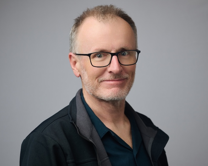 Man wearing glasses in-front of white background