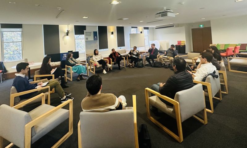 A group of people sitting in chairs in a circle