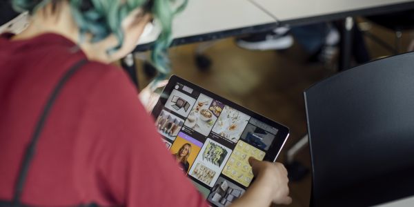 Detail of student looking at design work on a device