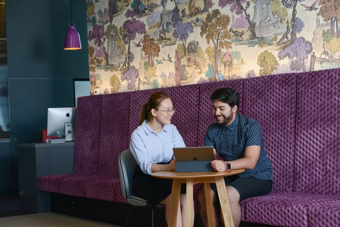 two students sitting a desk