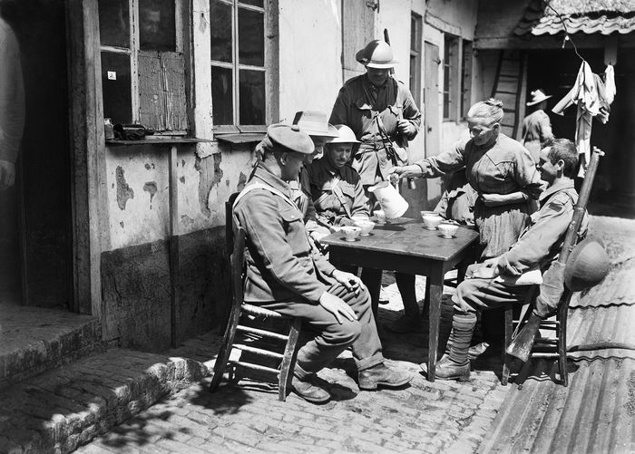 black and white photo of lady serving drink to soldiers