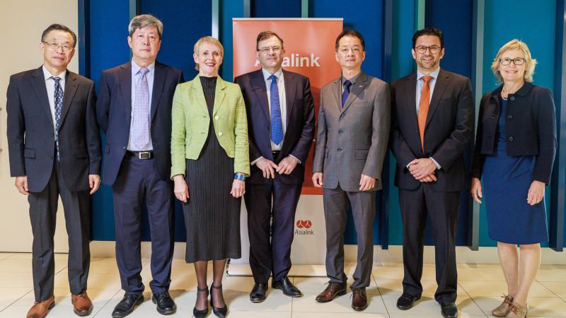 From Left to Right: Professor Mark Wang, Mr Chunming Guo, Ms Martine Letts, Professor Duncan Maskell, Consul-General Jianhua Zeng, Professor Michael Wesley, Professor Sarah Biddulph. Standing in-front of Asialink banner