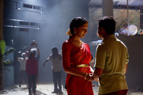 A man and a woman holding hands on stage