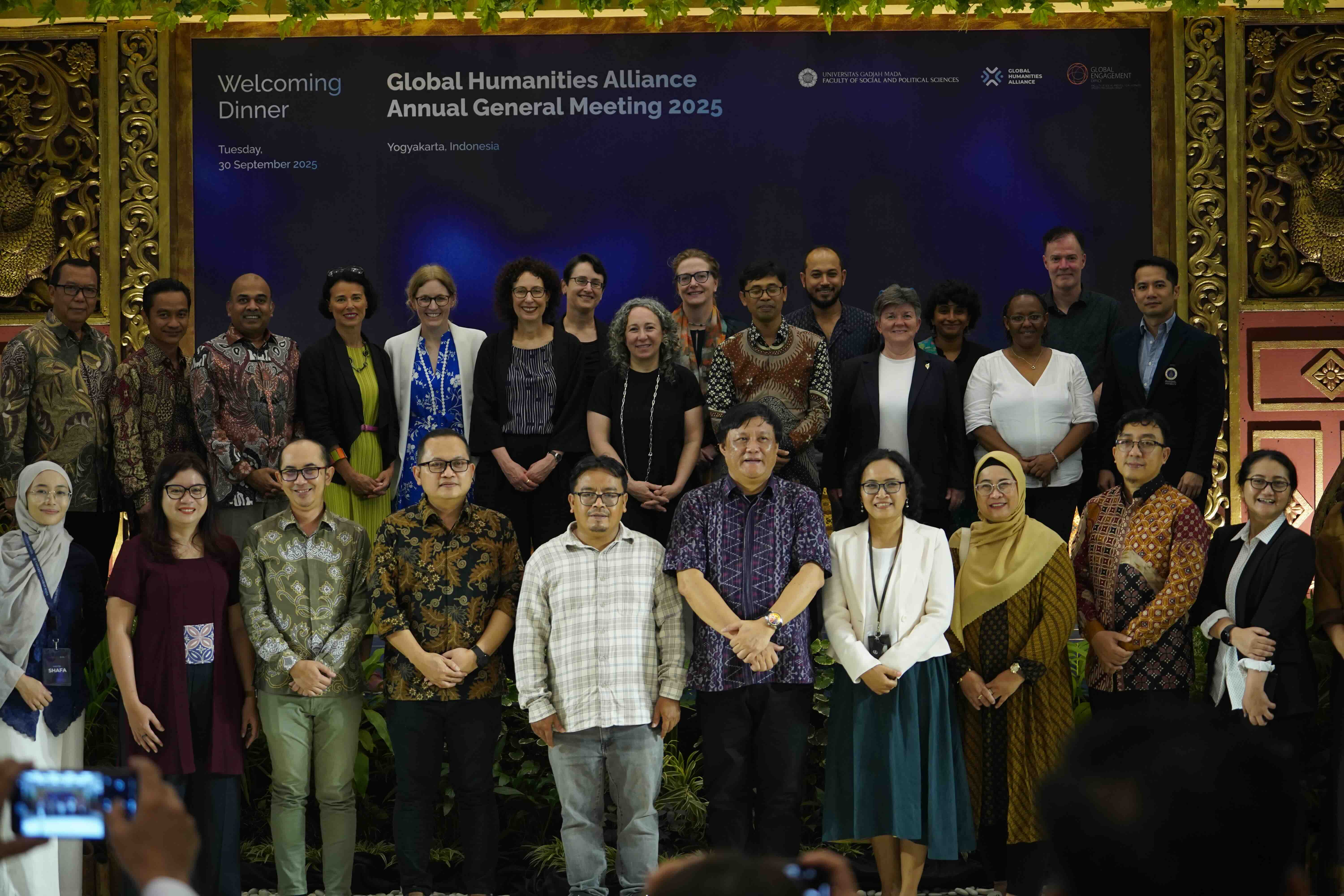 A large group of people at a conference stand together