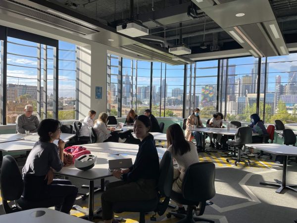 Classroom withs students in Arts West overlooking a view of the campus