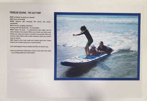 woman and two children on surfboard together laughing as they surf in the waves