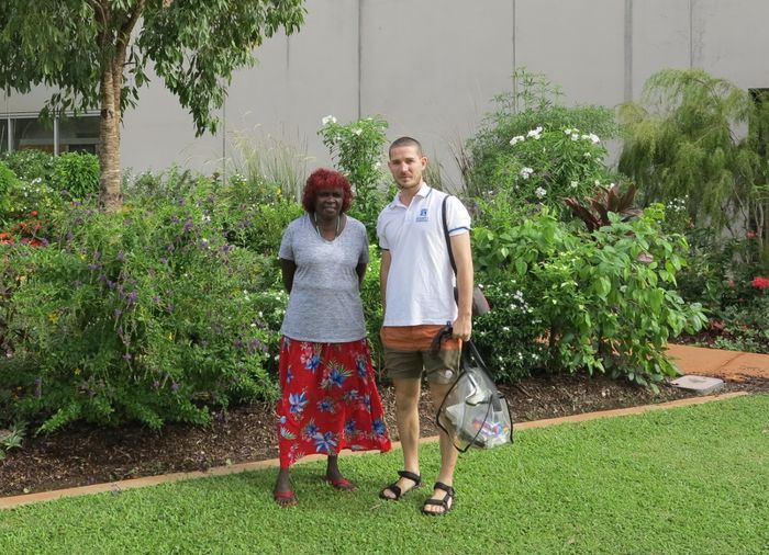 two people standing in front of garden