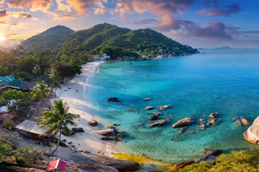 Birdseye view of an island at sunset