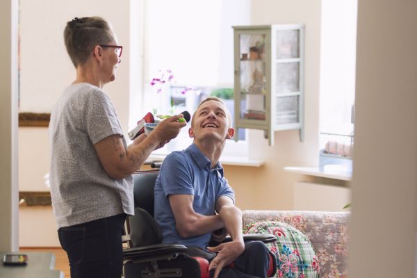 Person with cerebral palsy with their carer