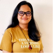 A woman wearing glasses and a yellow shirt