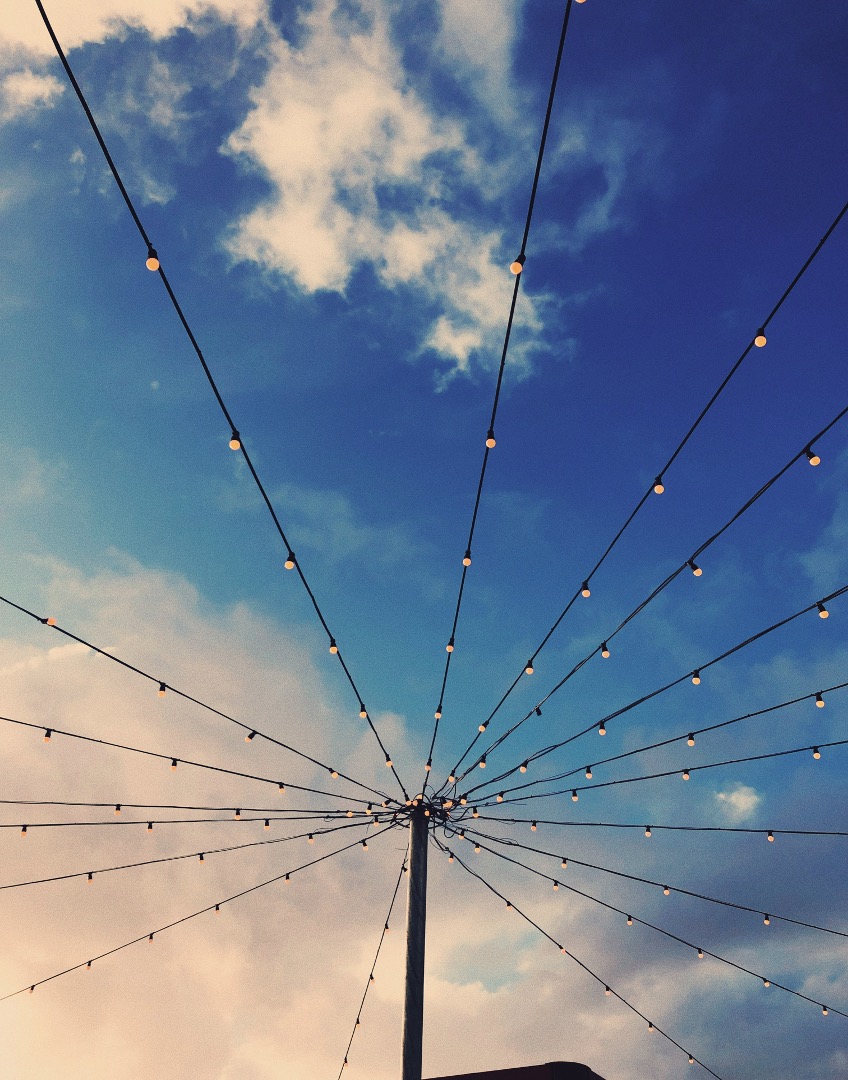 Lights attached to a column with a blue sky background