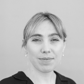 Black and white image of woman in front of white back drop