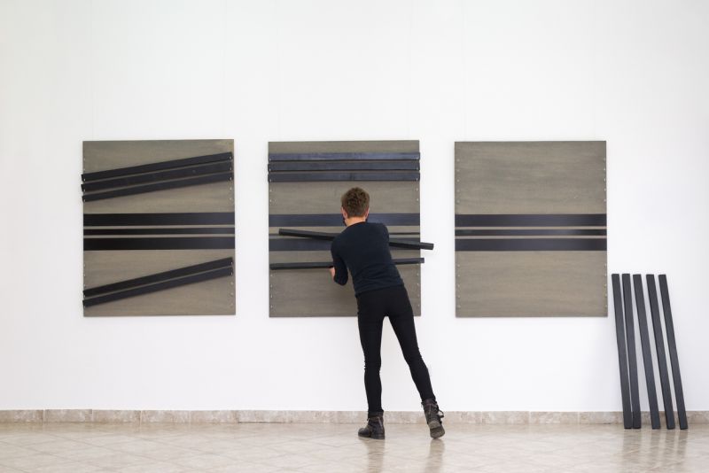 Female artist assembling her conceptual art in the art gallery before an exhibition.
