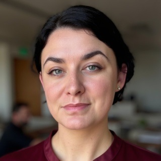 woman with blue eyes and black hair with office backdrop