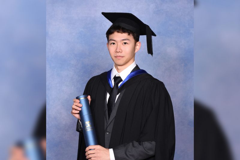 A graduate portrait of Peter Chen in cap and gown.