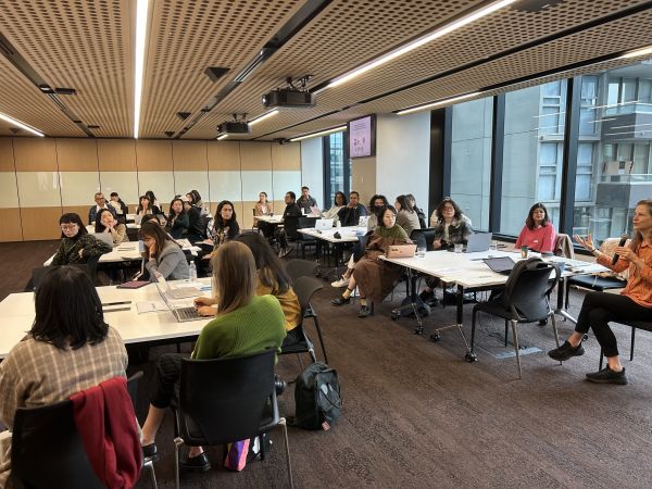 Around 40 people sitting around tables