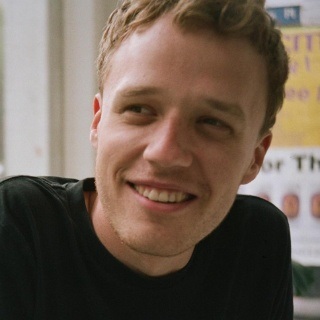 man smiling, looking into distance